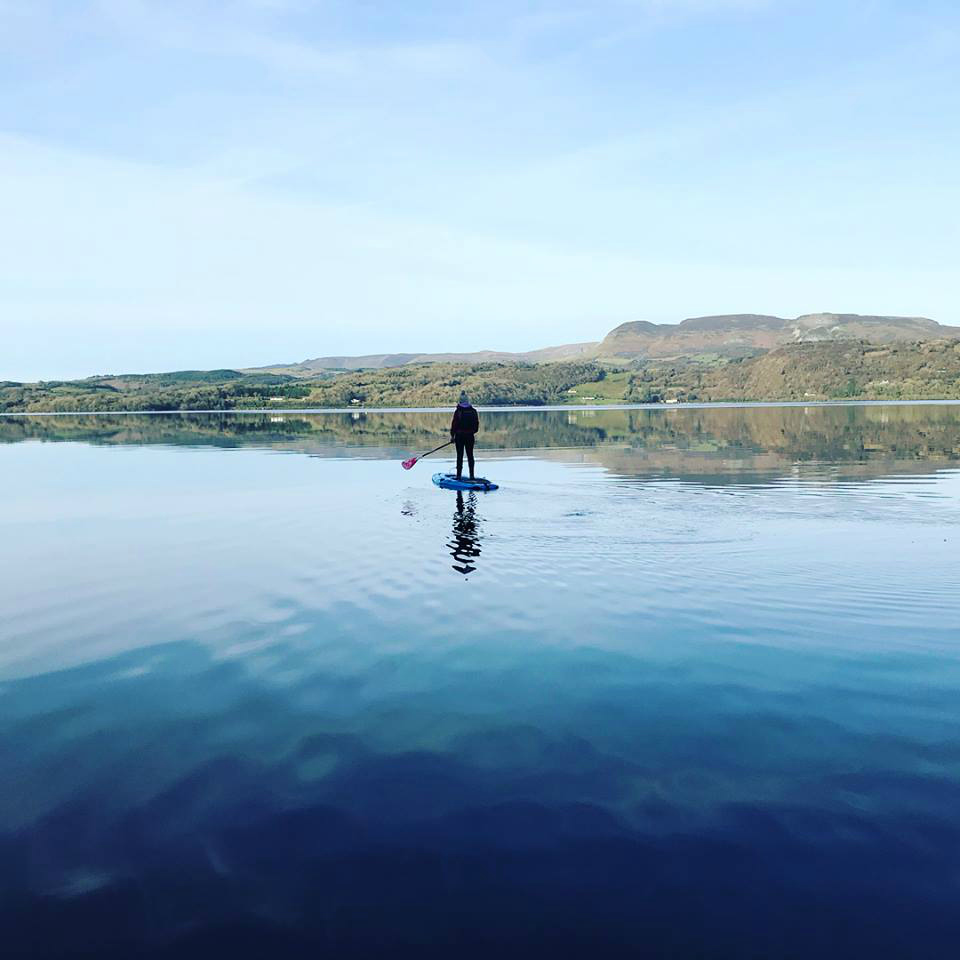 A paddler on the glassy waters of Lough Gill
