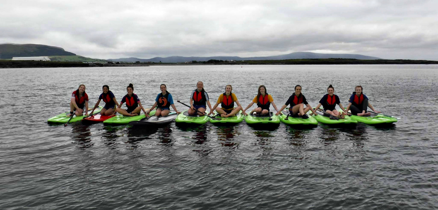 A hen party group sitting on paddleboards