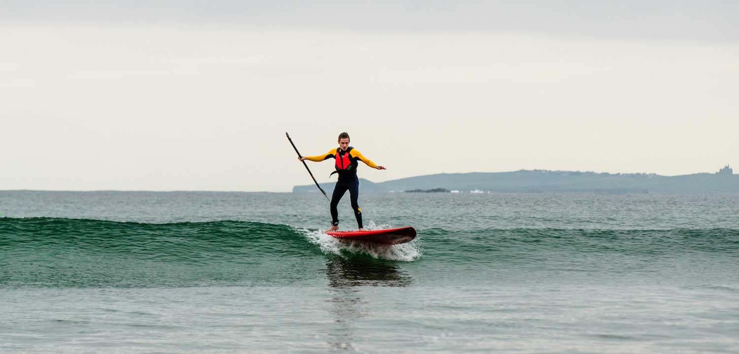 A paddler riding a small wave
