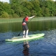 Boy learning to use stand up paddle board